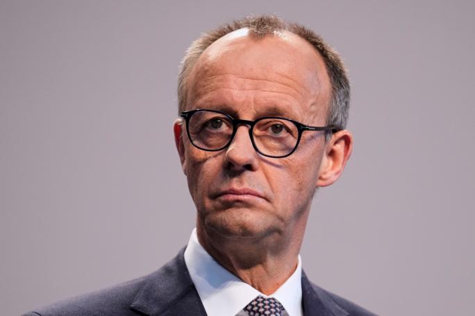 Friedrich Merz, Christian Democratic Union party chairman, addresses the media after reaching an agreement between their parties on a coalition for a new German government at a news conference in Berlin, Germany, Wednesday, April 9, 2025. (AP Photo/Ebrahim Noroozi)