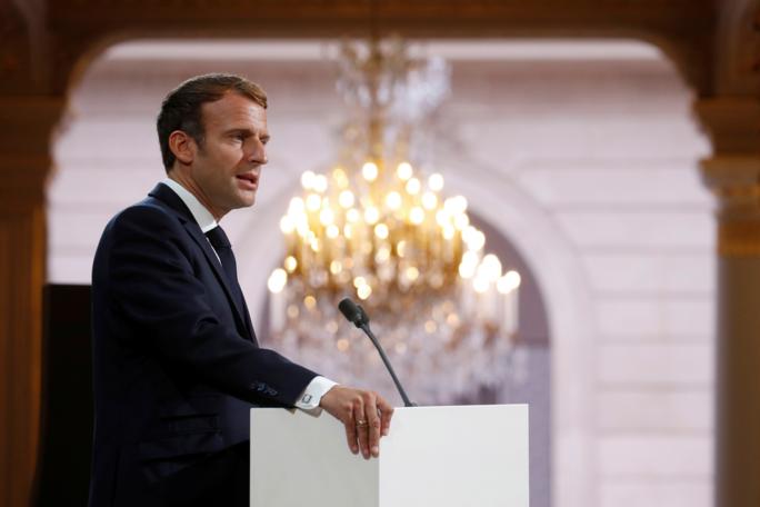 French President Emmanuel Macron delivers a speech during a meeting in memory of the Algerians who fought alongside French colonial forces in Algeria's war, known as Harkis, at the Elysee Palace in Paris, Thursday, Sept. 20, 2021. Macron's speech is the latest step in his efforts to reconcile France with its dark colonial past, especially in Algeria. (Gonzalo Fuentes/Pool Photo via AP)