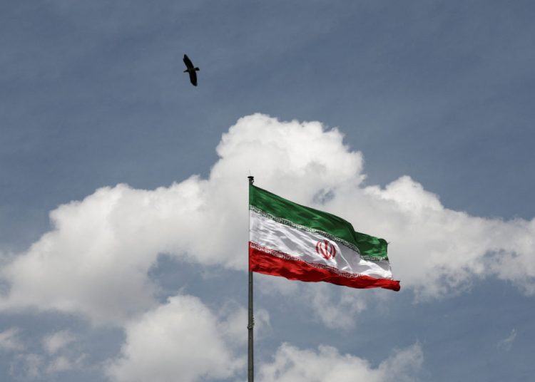 A bird flies over an Iranian flag, amid a ceasefire between U.S. and Iran, in Tehran, Iran, April 27, 2026. Majid Asgaripour/WANA (West Asia News Agency) via REUTERS ATTENTION EDITORS - THIS PICTURE WAS PROVIDED BY A THIRD PARTY