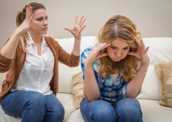 Furious young mother in a discussion with her teenage daughter. Problems between generations concept