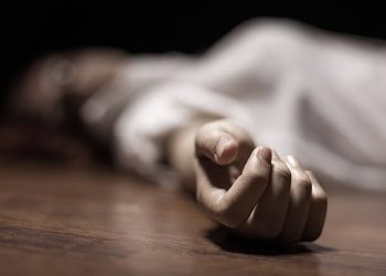 The dead woman's body. Focus on hand